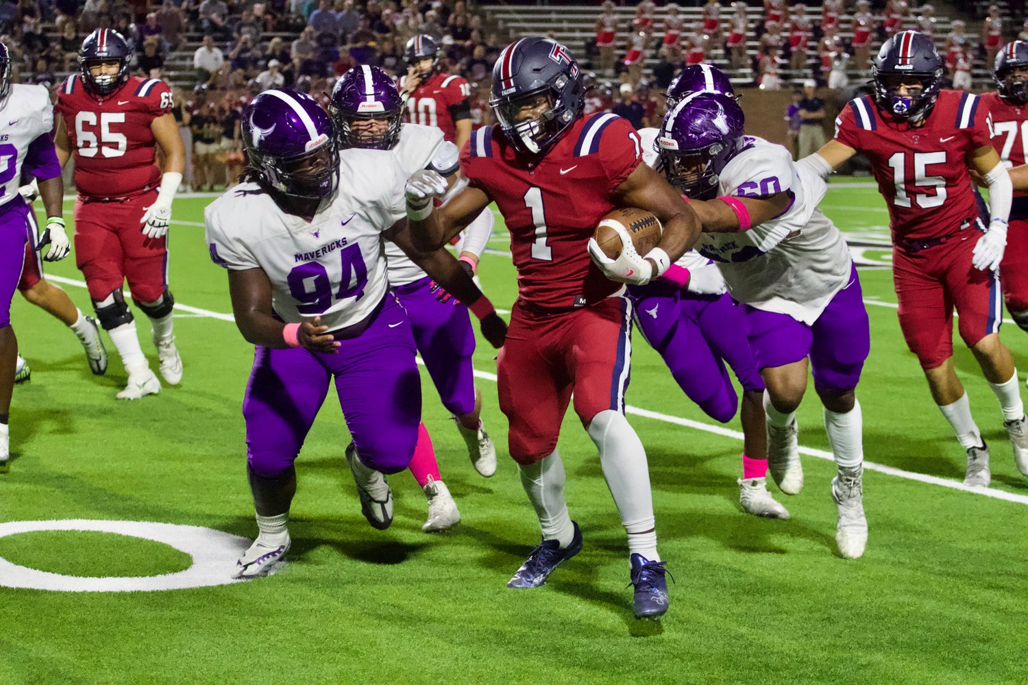 Caleb Komolafe tries to break tackles during Thursday's game between Tompkins and Morton Ranch at Rhodes Stadium.
